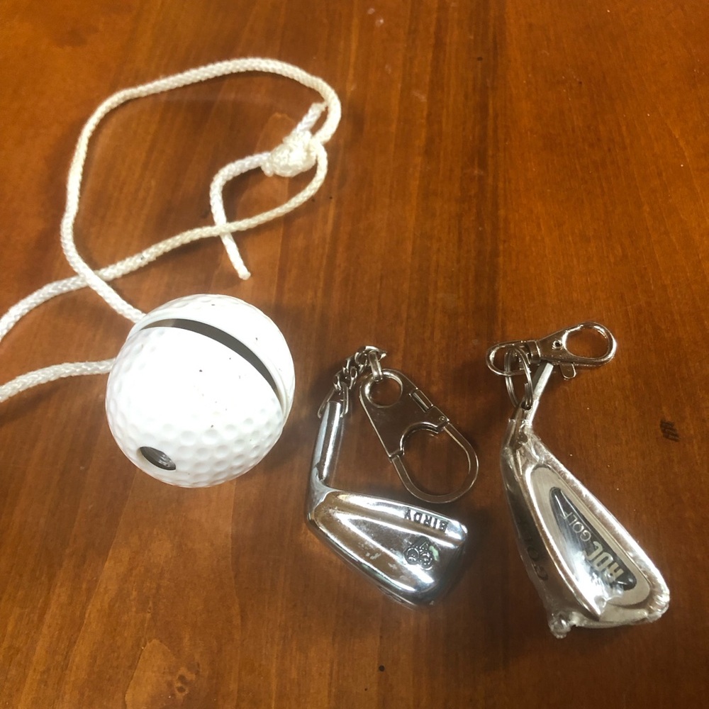 Pair of miniature golf club keychains and golf ball binocular.